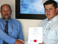 Pierre Enslin, BM Trada (left) hands the coveted ISO certificate to Albert Bower, managing director of Becker Electronics